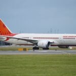 An Air India Boeing 787 aircraft taxiing on the runway during the day, representing the airline's international fleet.